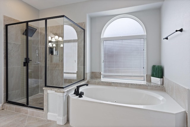 bathroom with a stall shower and a garden tub