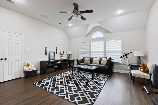 living area with visible vents, vaulted ceiling, and wood finished floors