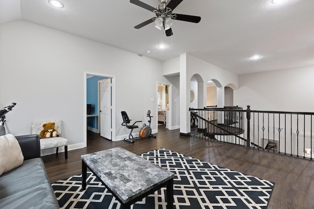 living room featuring lofted ceiling, recessed lighting, baseboards, and wood finished floors