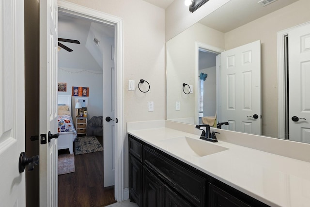 bathroom featuring visible vents, a ceiling fan, connected bathroom, wood finished floors, and vanity