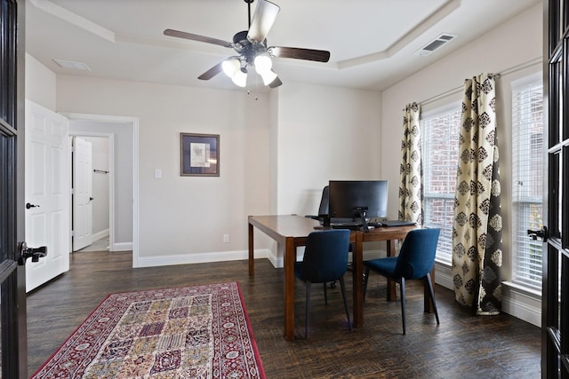 office featuring a raised ceiling, visible vents, baseboards, and wood finished floors