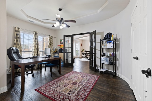 office featuring a wealth of natural light, french doors, a raised ceiling, and wood finished floors