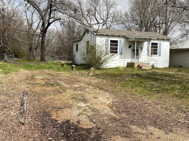 bungalow-style house with fence