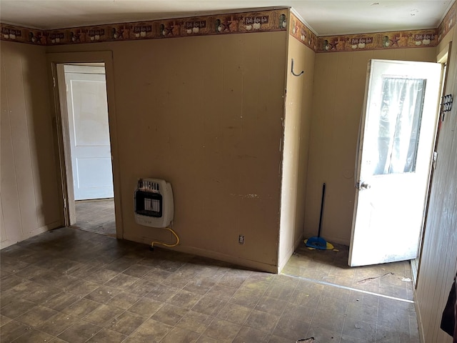 unfurnished room featuring tile patterned floors and heating unit