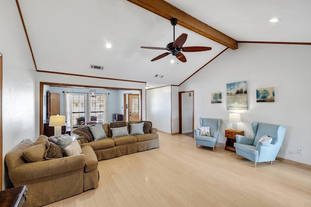 living area with visible vents, a ceiling fan, beam ceiling, light wood finished floors, and crown molding