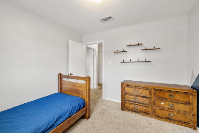 bedroom featuring light colored carpet, visible vents, and baseboards