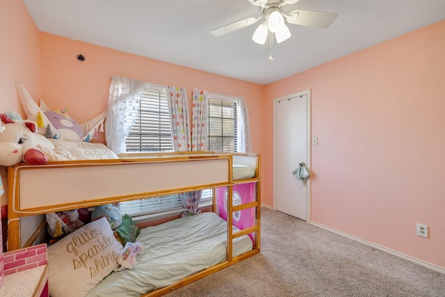 carpeted bedroom featuring ceiling fan and baseboards