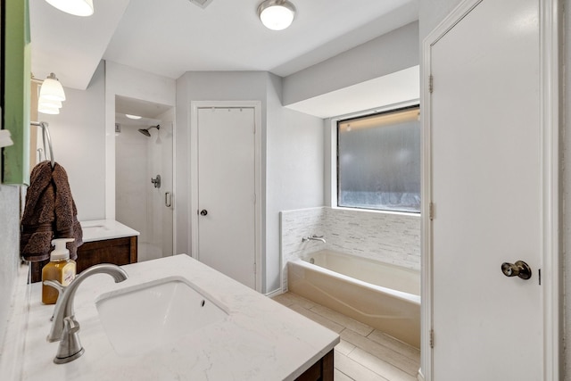 full bath with a garden tub, vanity, and a shower stall