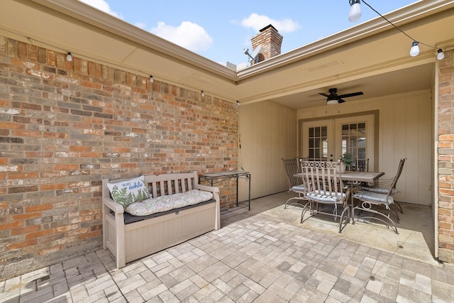 view of patio featuring outdoor dining space, french doors, and ceiling fan