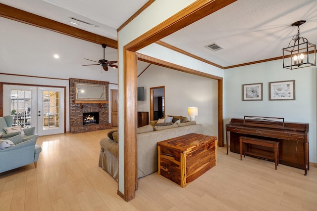 interior space with vaulted ceiling with beams, light wood-style floors, visible vents, and crown molding