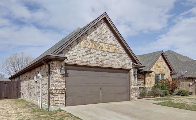 view of front facade featuring an attached garage, fence, brick siding, and driveway