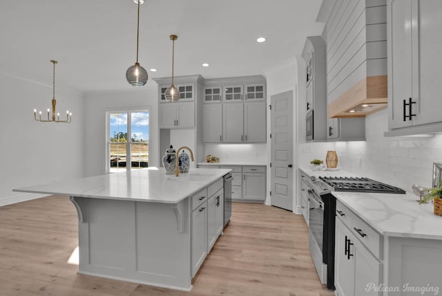 kitchen featuring a sink, custom range hood, appliances with stainless steel finishes, backsplash, and crown molding