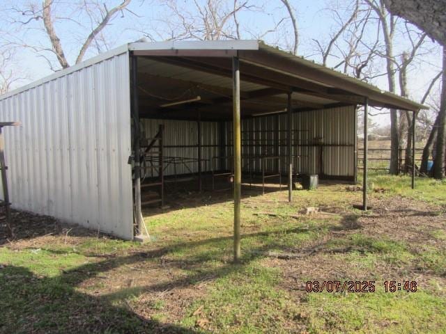 view of pole building with a carport and driveway