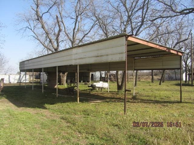 view of car parking with driveway and a detached carport