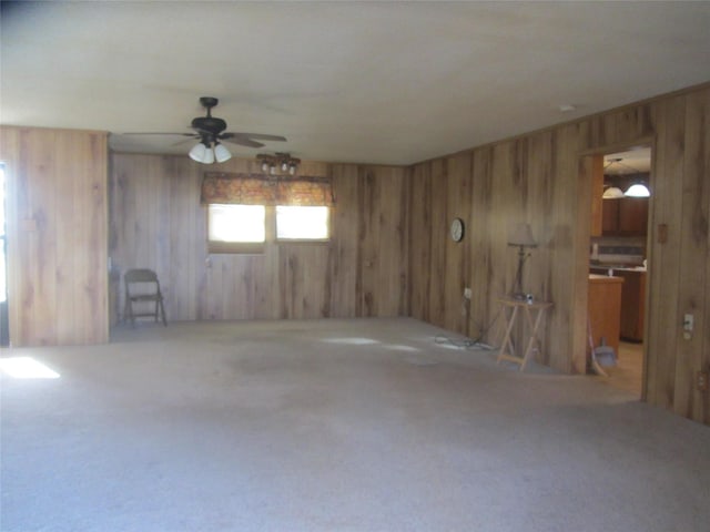 carpeted empty room with wood walls