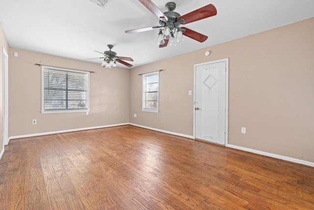 unfurnished room featuring baseboards and wood finished floors