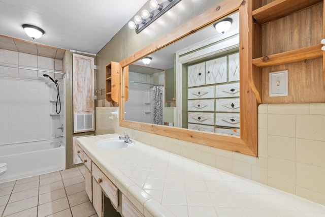 bathroom featuring tile walls, visible vents, shower / bathtub combination with curtain, vanity, and tile patterned floors