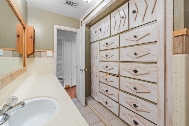 bathroom with visible vents, a sink, and tile patterned floors