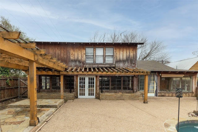 rear view of property featuring french doors, a patio, fence, and a pergola