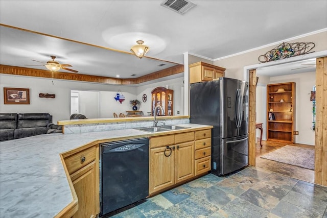 kitchen with black dishwasher, light countertops, visible vents, freestanding refrigerator, and a sink