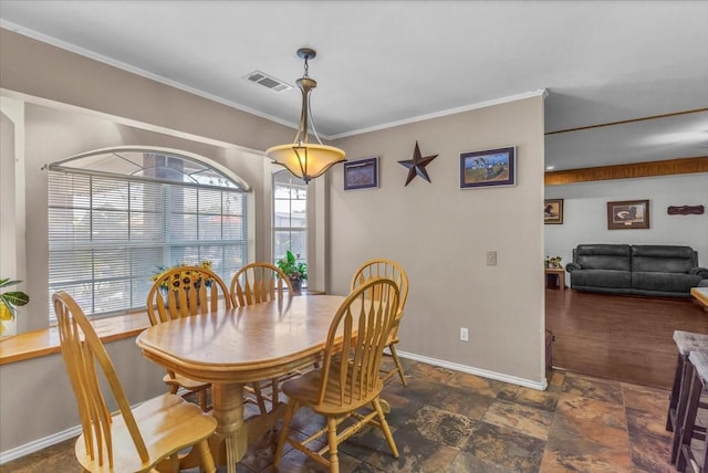 dining room with ornamental molding, visible vents, and baseboards