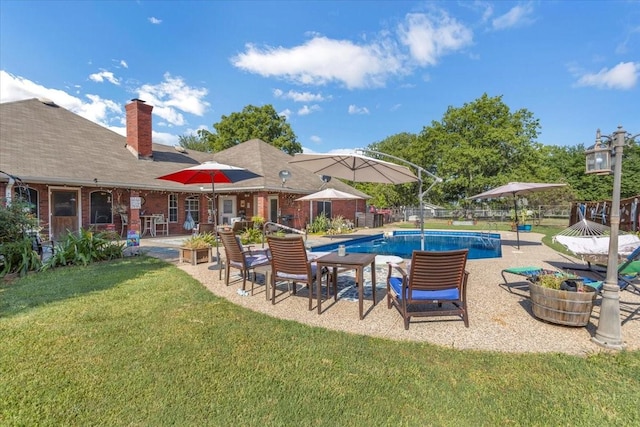 outdoor pool featuring a patio area, fence, and a yard