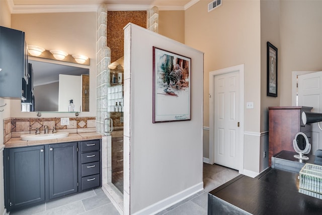 full bathroom with tile patterned flooring, visible vents, ornamental molding, a stall shower, and vanity