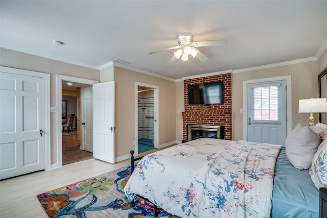 bedroom with baseboards, light wood-style flooring, ceiling fan, ornamental molding, and a brick fireplace