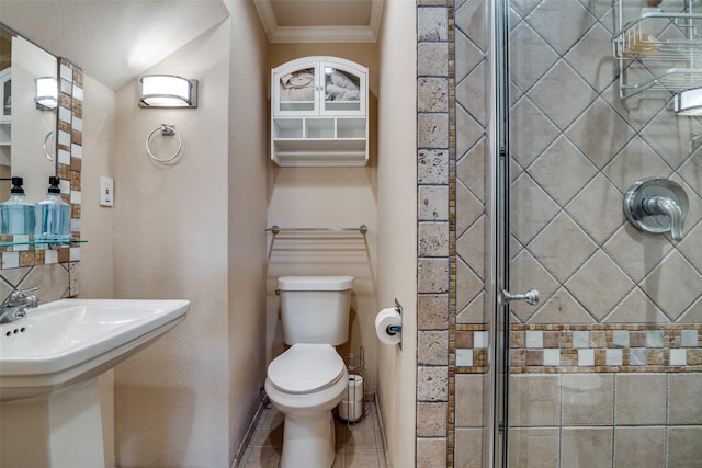 full bath with tile patterned floors, toilet, ornamental molding, and a shower stall