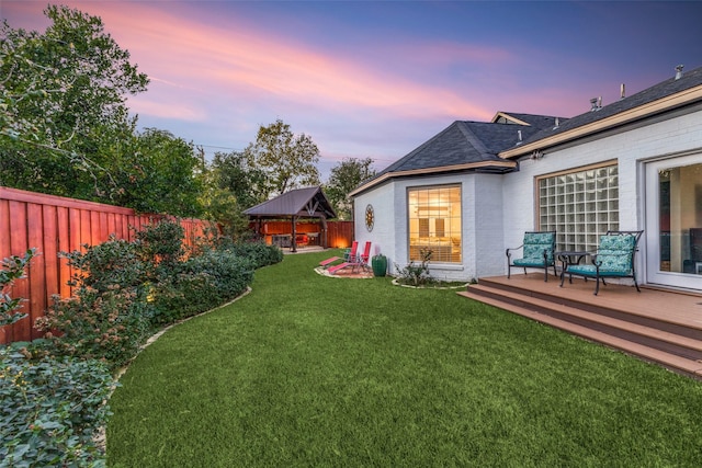 view of yard with a gazebo, a wooden deck, and a fenced backyard