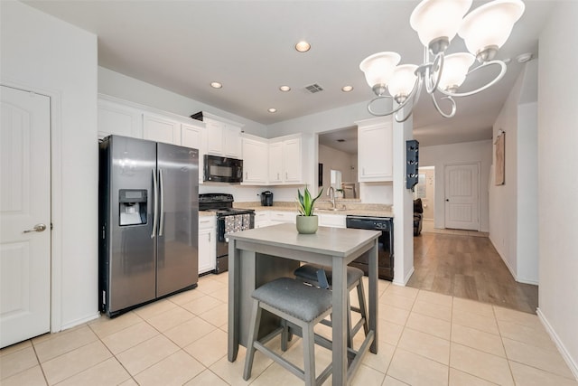 4041 Merriman Dr, Heartland, TX 75126 - kitchen with light tile patterned flooring, light countertops, visible vents, black appliances, and an inviting chandelier