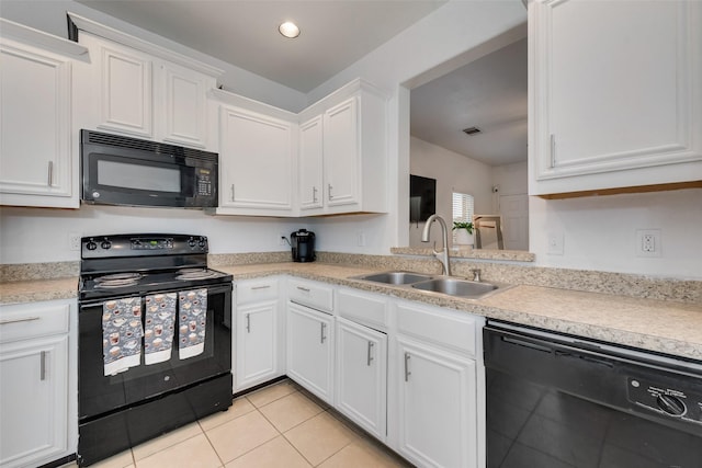 kitchen featuring black appliances, a sink, white cabinets, light countertops, and light tile patterned floors