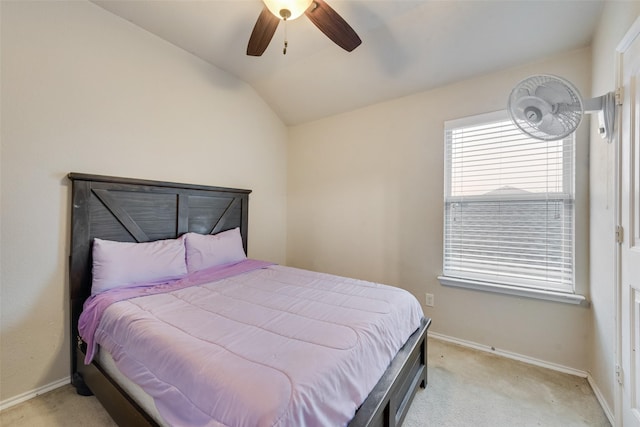 bedroom with baseboards, lofted ceiling, light colored carpet, and a ceiling fan