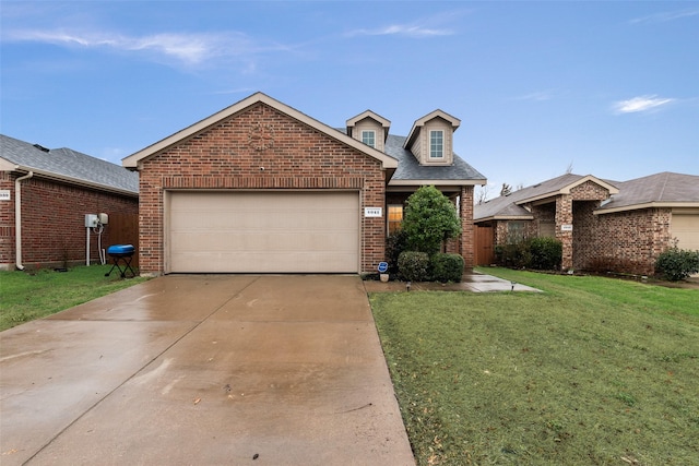 view of front of home with a front yard, brick siding, concrete driveway, and an attached garage