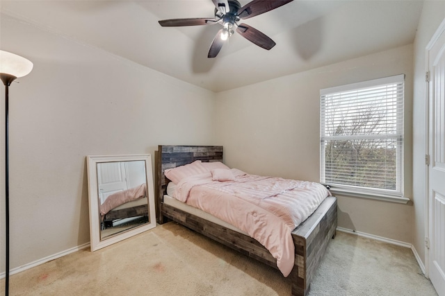 carpeted bedroom with baseboards and ceiling fan