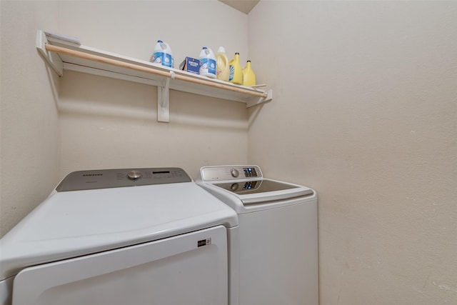 laundry area with washing machine and clothes dryer and laundry area