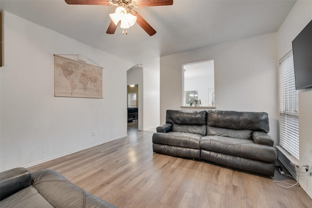 4041 Merriman Dr, Heartland, TX 75126 - living area featuring baseboards, arched walkways, wood finished floors, and ceiling fan