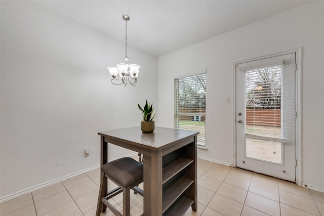 4041 Merriman Dr, Heartland, TX 75126 - dining room featuring baseboards, lofted ceiling, a chandelier, and light tile patterned floors