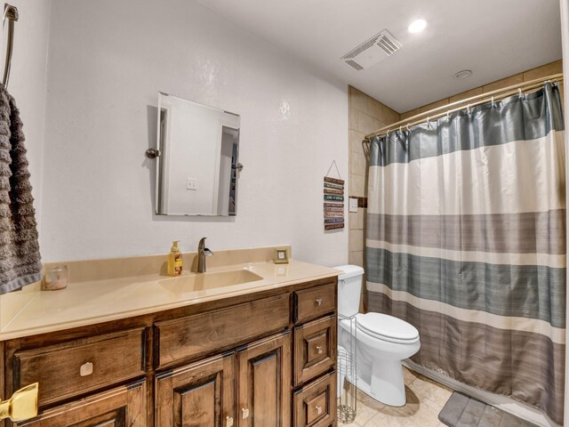 bathroom featuring visible vents, toilet, a shower with curtain, tile patterned flooring, and vanity