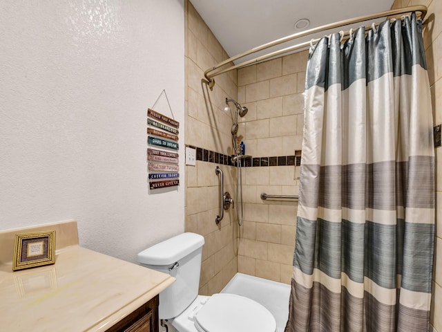 full bathroom with vanity, toilet, a textured wall, and a tile shower