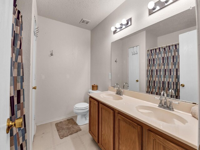 full bath with a sink, visible vents, toilet, and a textured ceiling