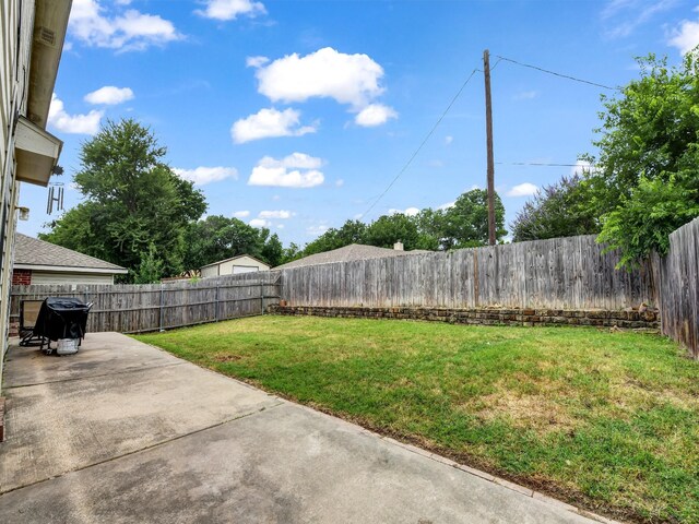 view of yard with a fenced backyard and a patio area