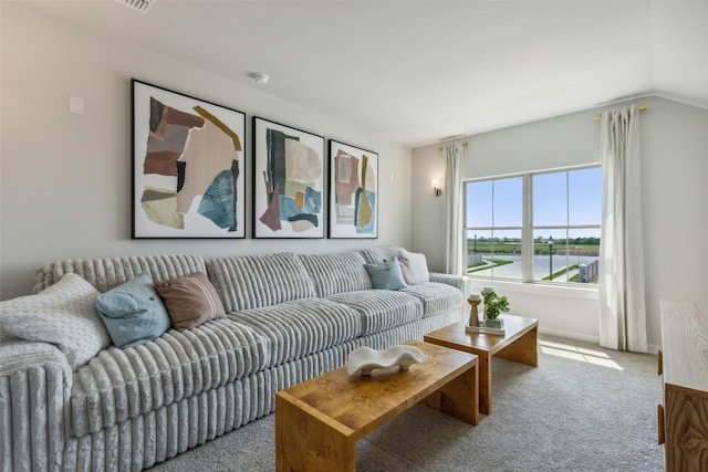 carpeted living area with lofted ceiling