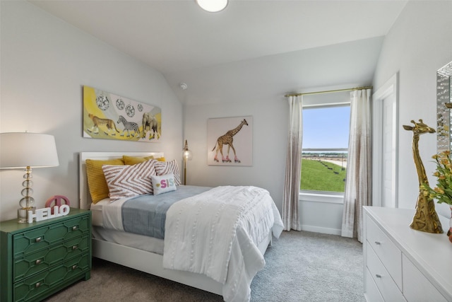 carpeted bedroom with baseboards and lofted ceiling