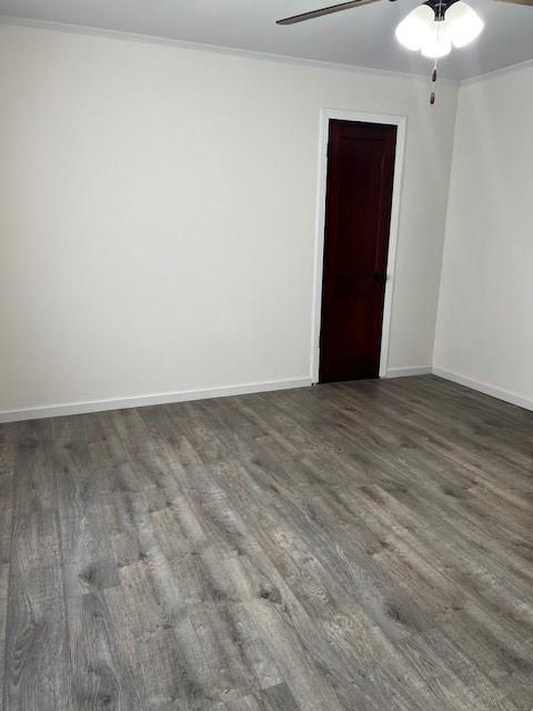 unfurnished room with crown molding, wood finished floors, baseboards, and ceiling fan