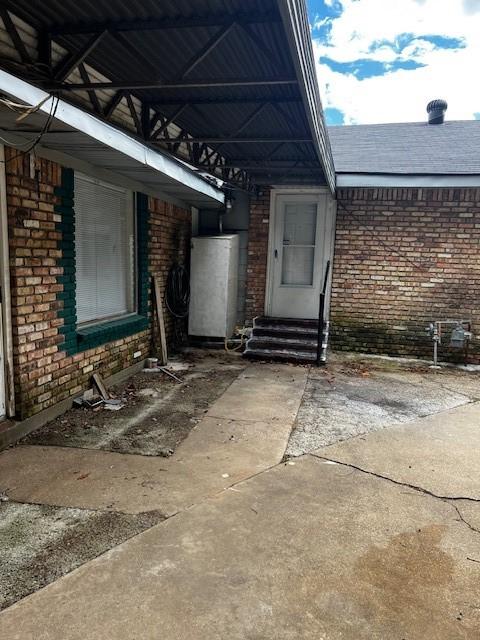 view of patio / terrace with water heater and entry steps