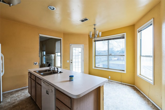 kitchen featuring visible vents, a healthy amount of sunlight, dishwasher, and a sink