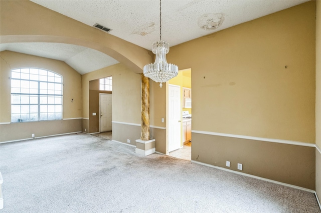 carpeted empty room featuring visible vents, a textured ceiling, arched walkways, a chandelier, and vaulted ceiling