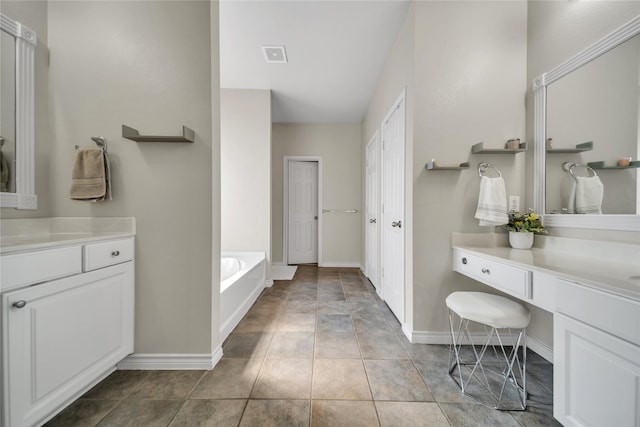 full bath featuring visible vents, baseboards, a bath, and vanity