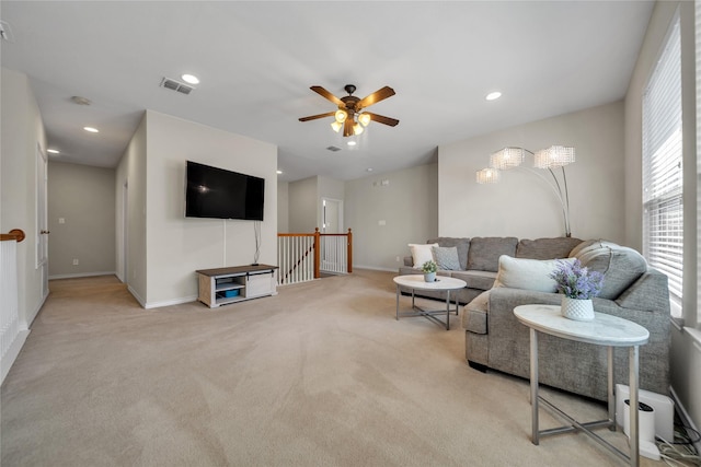 living room featuring recessed lighting, visible vents, baseboards, and light colored carpet